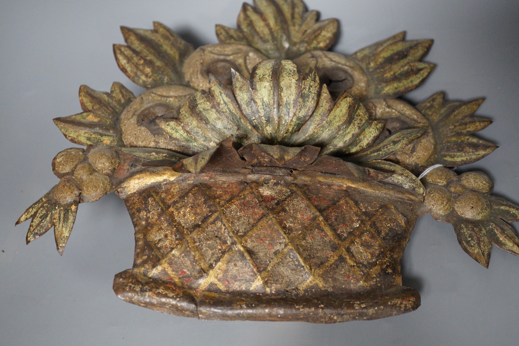 A painted embossed iron flower basket ornament